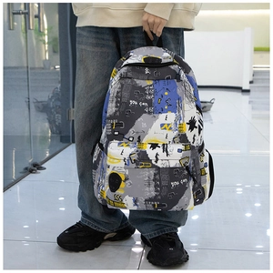 Detail view of graffiti print backpack with front zipper pocket and side water bottle slot