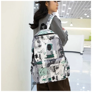 Detail of artistic graffiti backpack with durable canvas texture and spacious pockets