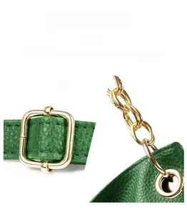 Detail of green litchi texture leather shoulder bag with glossy gold hardware latch