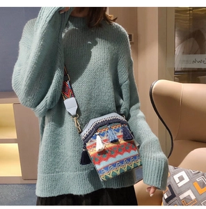 Detail of bohemian bucket bag featuring colorful woven patterns and elegant tassels