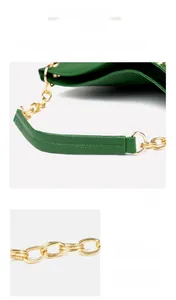 Detail of green litchi texture leather handbag with reinforced gold metal chain handle