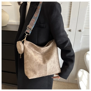 Detail of vintage mocha bucket bag with ethnic patterned wide strap and mini coin pouch