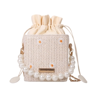 Straw drawstring bucket bag with daisy embroidery and large pearl chain handle