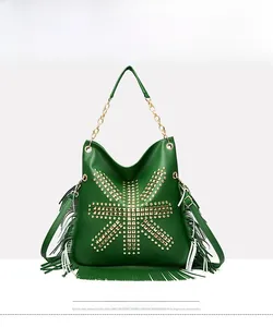 Detail of green punk shoulder bag featuring metallic gold studs and long leather tassels