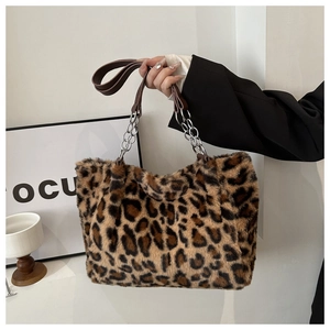 Detail of leopard print faux fur tote bag showing metal chain and leather straps