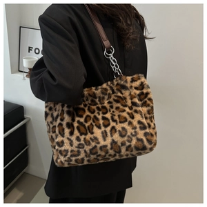 Detail of leopard print faux fur tote bag with brown leather strap and chain
