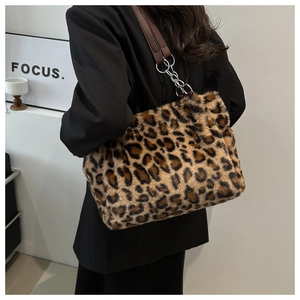 Detail of plush leopard print tote bag with brown leather and silver chain strap
