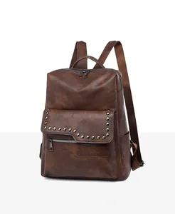 Detail view of vintage brown soft leather backpack with metallic rivets and texture