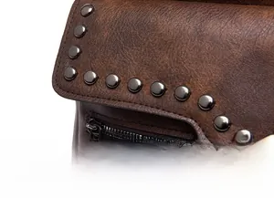 Close-up of vintage brown leather backpack with metal rivets and smooth zipper details