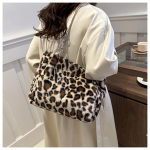 Detail of plush leopard print tote bag featuring a silver metal chain shoulder strap