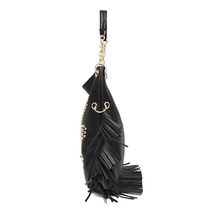 Detailed side view of black pebble leather crossbody bag with punk rivets and fringes
