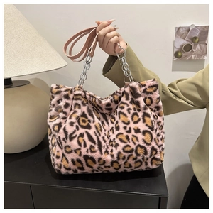 Detailed shot of pink leopard print plush tote bag with silver metal chain strap