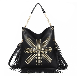 Close-up of black lychee grain leather with punk gold studs and long fringe details