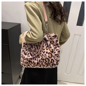 Detail of pink leopard print plush tote bag with faux fur texture and metal chain strap
