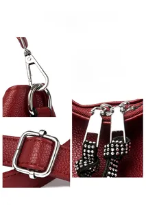 Detail of red pebbled leather bag featuring silver hardware and rhinestone zipper pull