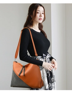 Detail of large tote bag featuring orange pebble leather and black-white checkered fabric