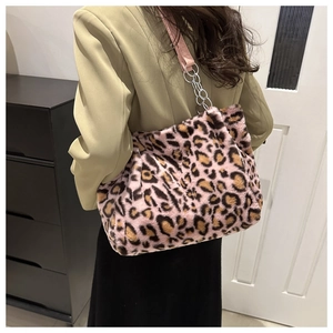 Detail of pink leopard plush tote bag with silver chain and leather shoulder strap