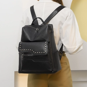 Women black minimalist PU leather backpack with silver studs shown on a model