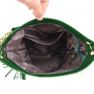 Detail view of large dark green shoulder bag interior with zipper pocket and metal chain