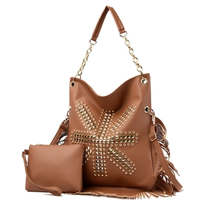 Close-up of brown leather hobo bag with gold metal studs, long tassels and chain strap