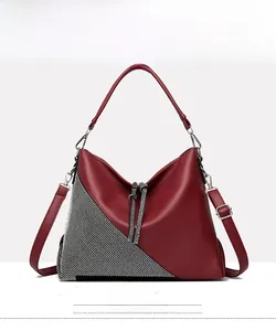 Front detail of a red pebbled leather tote with sparkling silver rhinestone patchwork