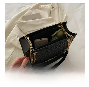 Interior view of the quilted black shoulder bag showing large capacity for phone and umbrella