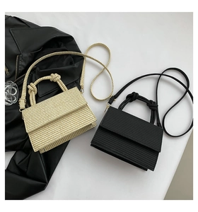 Detailed close-up of woven texture mini square bags in beige and black with gold hardware
