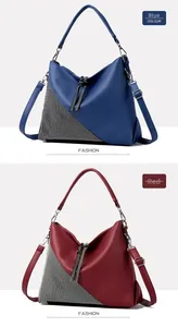 Detail of blue and red textured leather crossbody bags with sparkling rhinestone panels