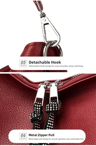 Detail of red lychee grain leather bag with silver hooks and rhinestone zipper pull