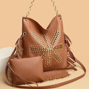 Caramel brown leather shoulder bag with punk studs, tassels and matching small pouch