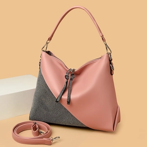 Detail of pink leather handbag with sparkling rhinestone side mesh and silver hardware