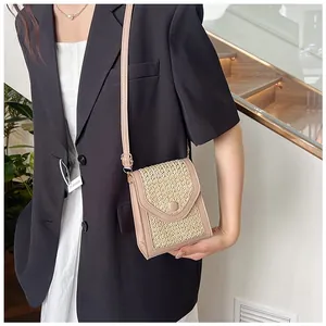 Straw woven crossbody bag for women shown with model in a stylish indoor setting