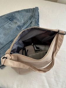 Minimalist beige corduroy tote bag showing large capacity with internal storage