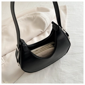 Detail view of the black crescent hobo bag showing its spacious interior capacity and zipper