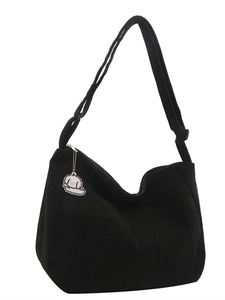 Black corduroy hobo crossbody bag with adjustable strap and cute dog charm on white background