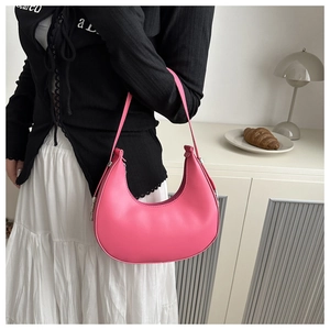 Detail of pink PU leather crescent hobo bag with smooth curved design and zipper closure