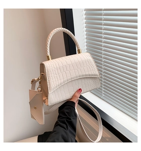 Détails du sac à motif crocodile crème avec poignée tressée et accents métalliques dorés