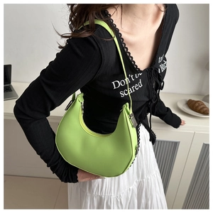 Detailed view of lime green crescent hobo bag with adjustable strap and silver metal buckle