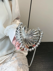 Metallic heart crossbody bag with radial texture and silver bead chain handle