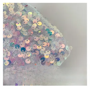 Detailed macro shot of iridescent sequins on the fabric of this stylish shoulder bag