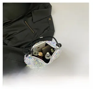 Top view of sequin shoulder bag showing interior capacity for phone and cosmetics