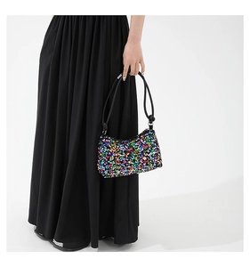 Detailed macro view of vibrant colorful sequins on a stylish sequined hobo shoulder bag