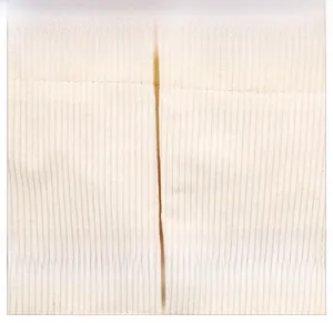 Detail of off-white corduroy tote bag showing vertical texture and leather fashion tag