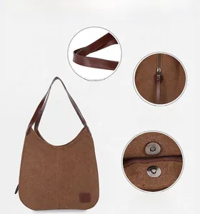 Détail du grand sac bandoulière en toile avec fermeture éclair et bouton magnétique