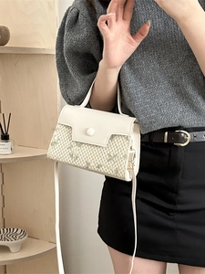 Elegant woven cream handbag with green floral embroidery and adjustable shoulder strap