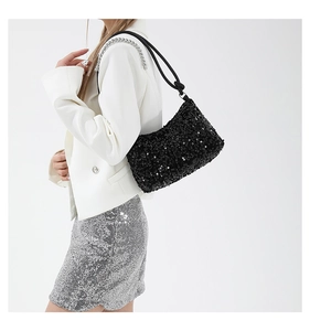 Detail of black sequined shoulder bag with round rope handle and silver metal chain strap