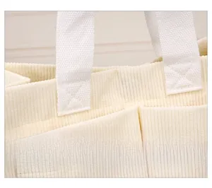 Close-up of reinforced X-shape stitching and corduroy texture on large tote bag