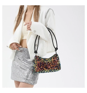 Detail of colorful sequins on stylish shoulder bag with metallic luster and black strap