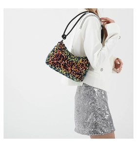 Detail of colorful sequin shoulder bag with silver metal chain and thin black strap