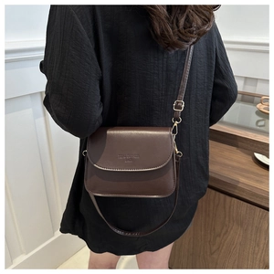 Détail de la bandoulière en cuir marron foncé avec boucle dorée Vital Dryness Bags